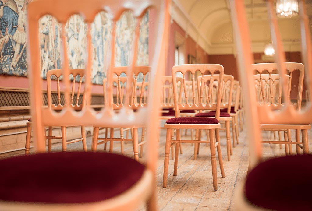 chairs set for wedding in The Long Gallery at Englefield Estate